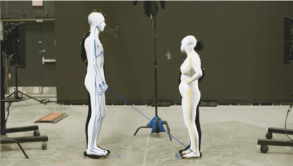 Two virtual characters face each other on a production set