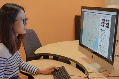 Laura Yuqin Yang working at a computer