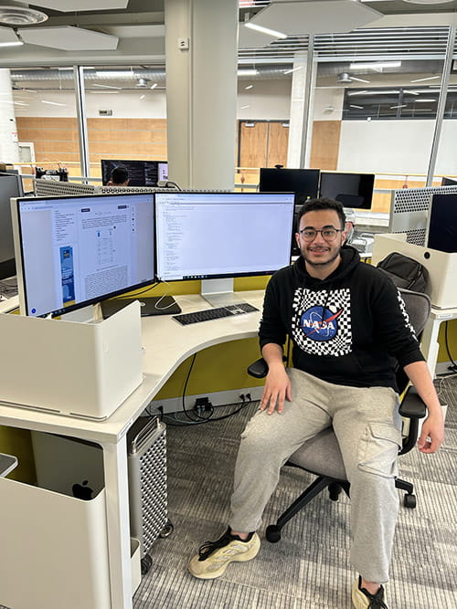 Sheridan student Mohamed Ahmed sits at a computer desk