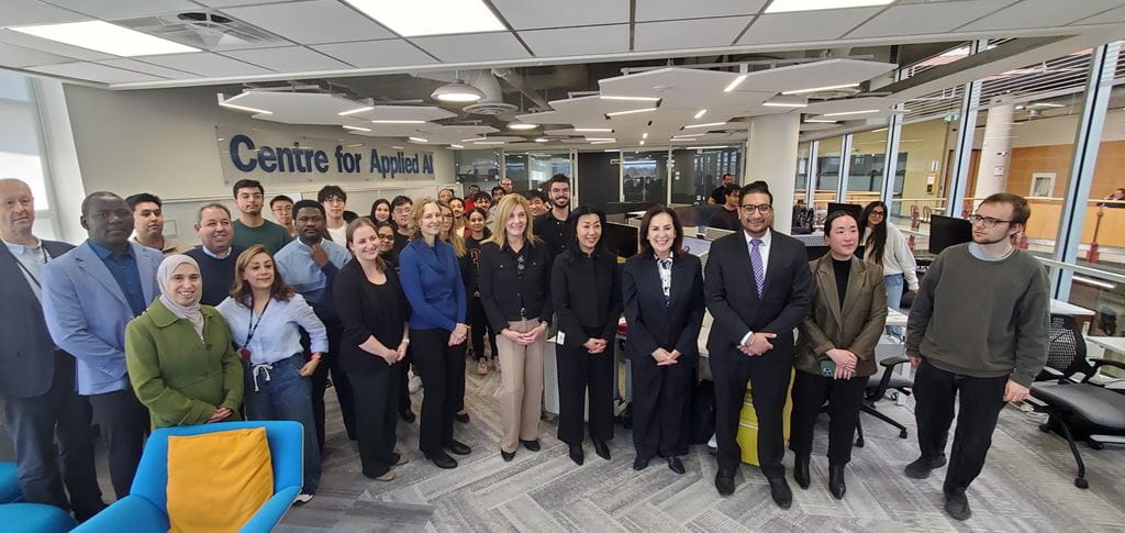Effie Triantafilopoulos, Oakville North-Burlington MPP and Deputy Speaker of the Legislative Assembly of Ontario, is pictured standing inside Sheridan's Centre for Applied AI with a large number of Sheridan administrators, faculty, staff and students