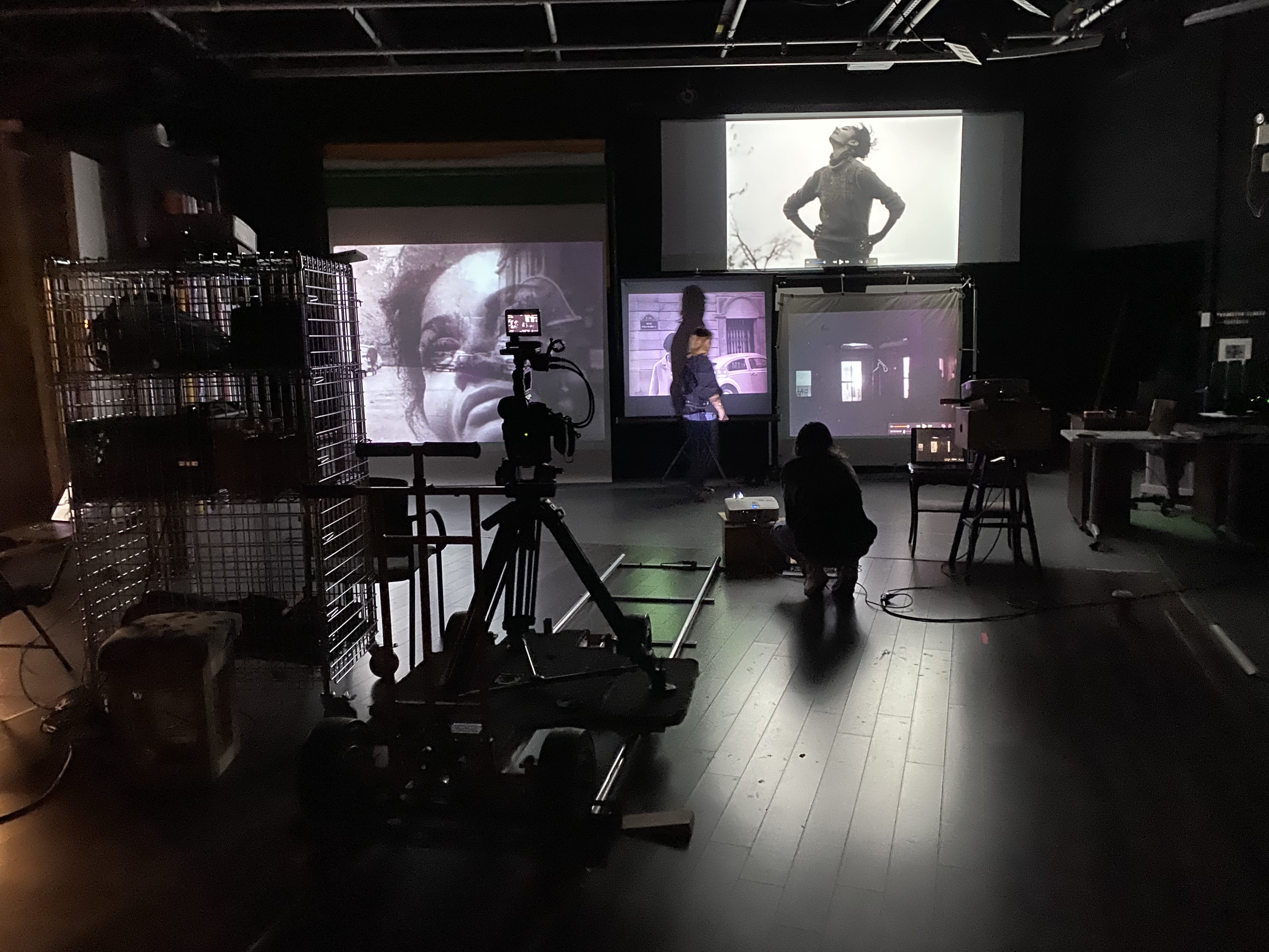 A research space with several large screens displaying black and white images