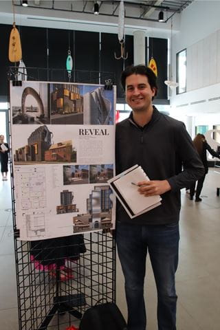 Sheridan student Manolo Mendoza stands beside a display of his project