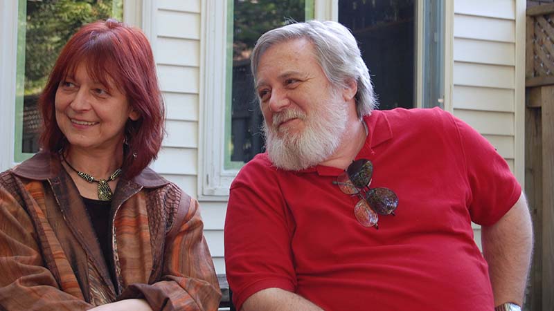 Dr. Dragana Martinovic and Dr. Victor Ralevich sitting side-by-side at the party for the first graduating class from the Bachelor of Applied Information Sciences - Information Systems Security program