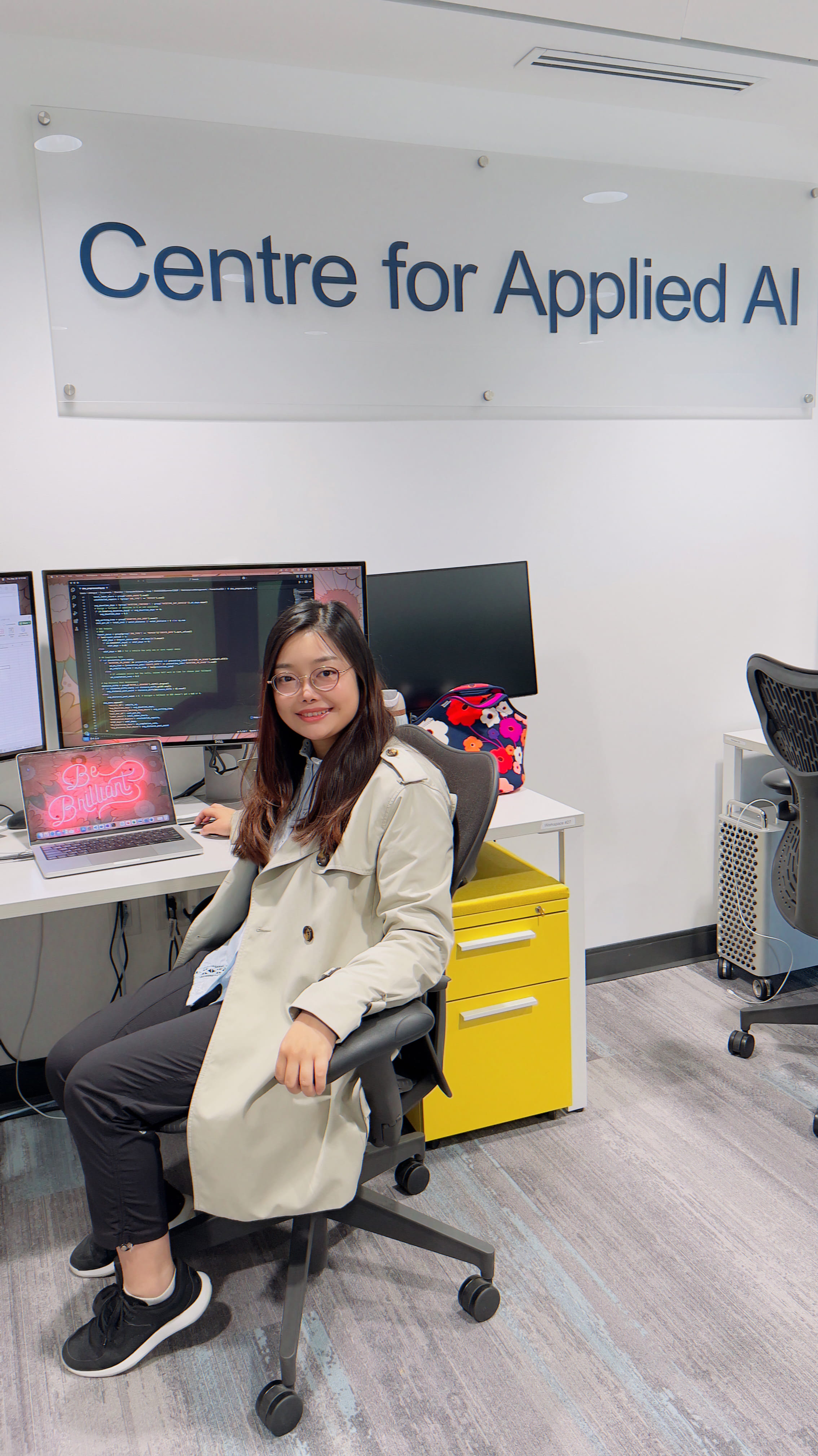 Sheridan computer science student Jinling Cai sits at a desk inside Sheridan's Centre for Applied AI