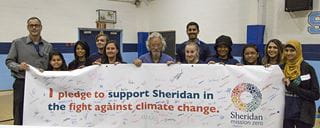 Herbert Sinnock, David Suzuki, and students hold a banner in support of Sheridan Mission Zero