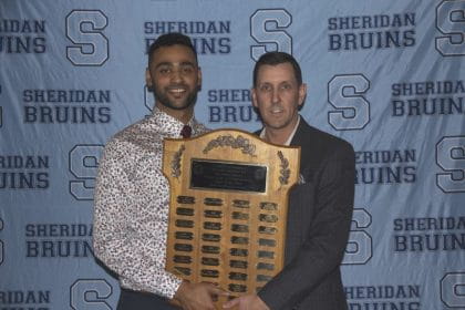 Omer Suhrawardy receiving an award from Paul Brisebois