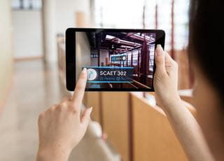 Student holding up a tablet to capture an image