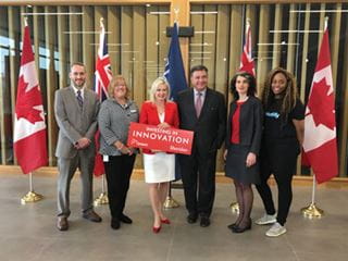 Members of Sheridan, the Ministry of Education, and the City of Mississauga pose for a photo at an innovation funding announcement event.