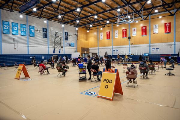 Sheridan Vaccine Clinic gym with clinic staff and guests