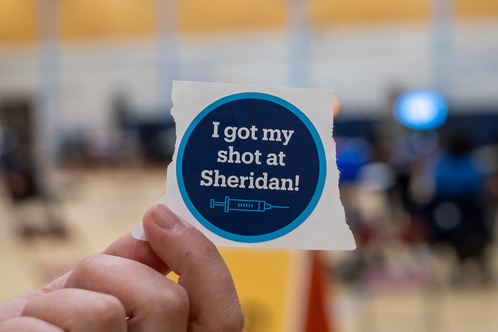 I got my shot at Sheridan sticker in the foreground with the clinic in the background