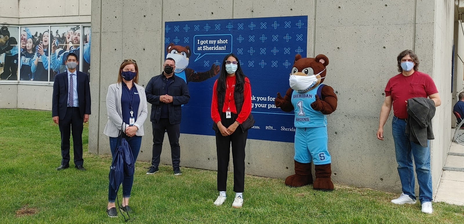 Dignitaries in front of "I got my shot"  banner