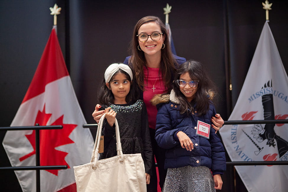 MPP for Mississauga Centre Natalia Kusendova standing with two children