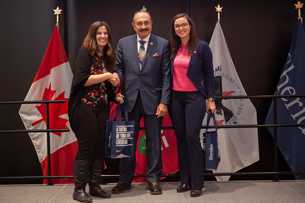 Three people standing side-by-side