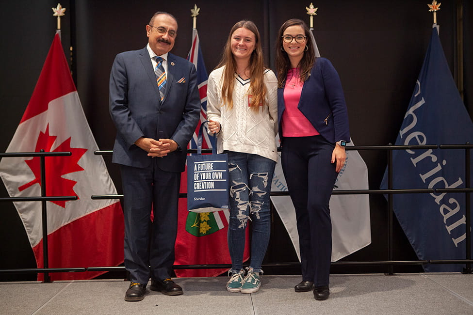 Three people standing side-by-side