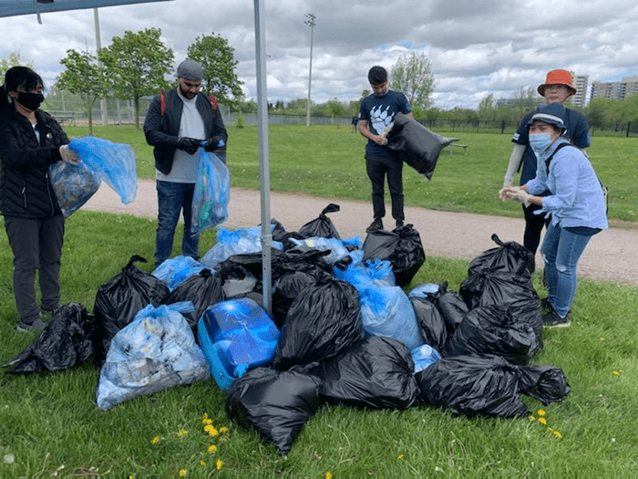 Park volunteers gather bags of garbage