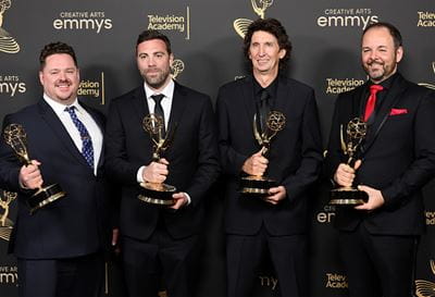 Sheridan alumnus Craig Henighan holding his Emmy Award, pictured second from right