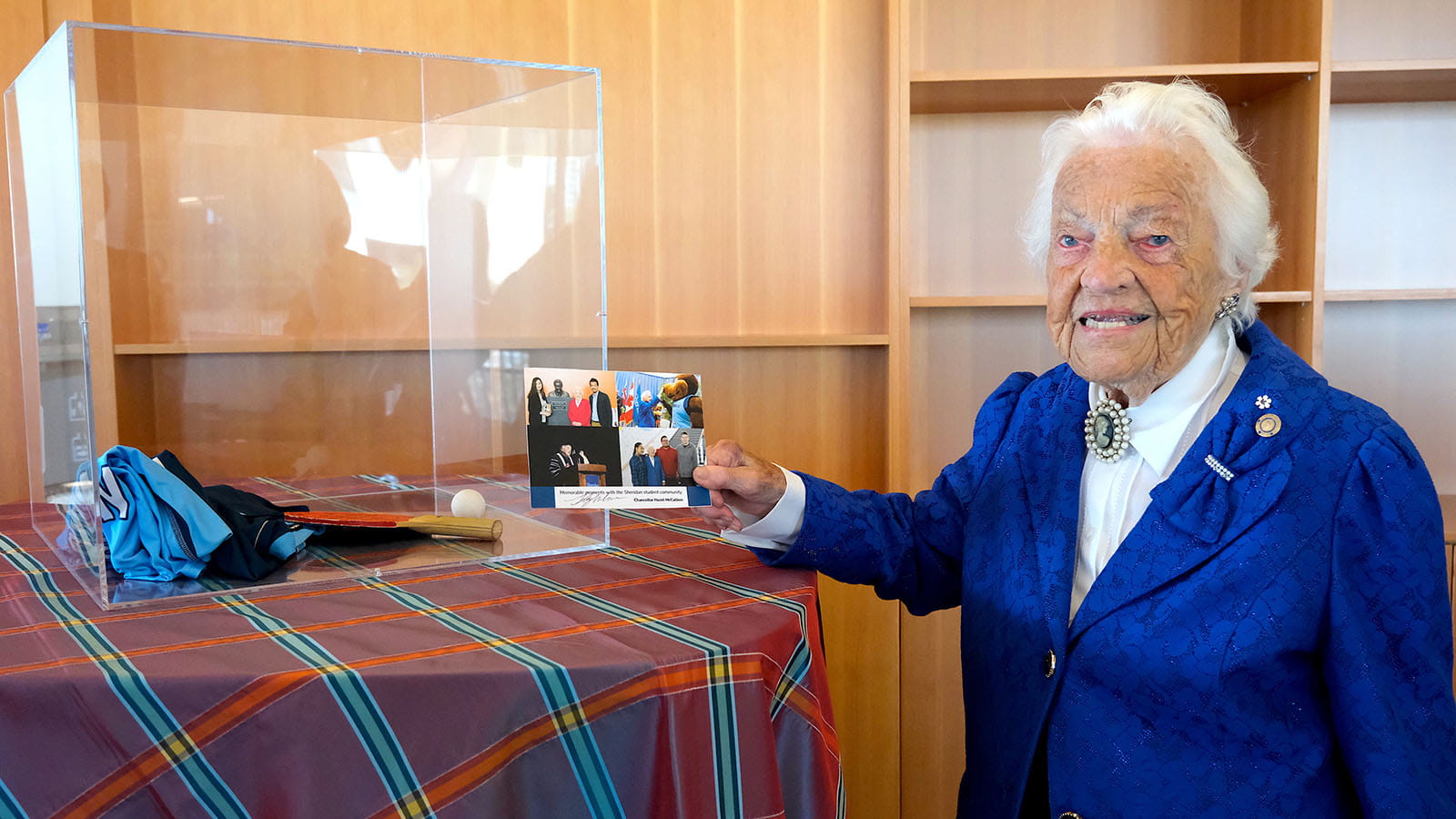 Hazel McCallion places a signed photo collage into a clear memento box