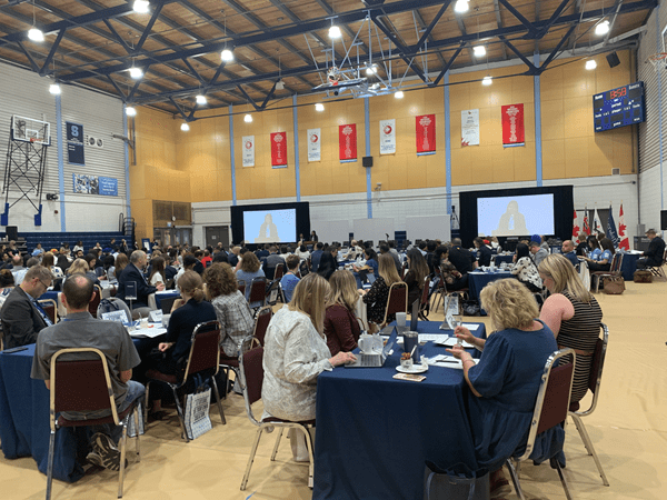 Attendees at tables at Davis gym