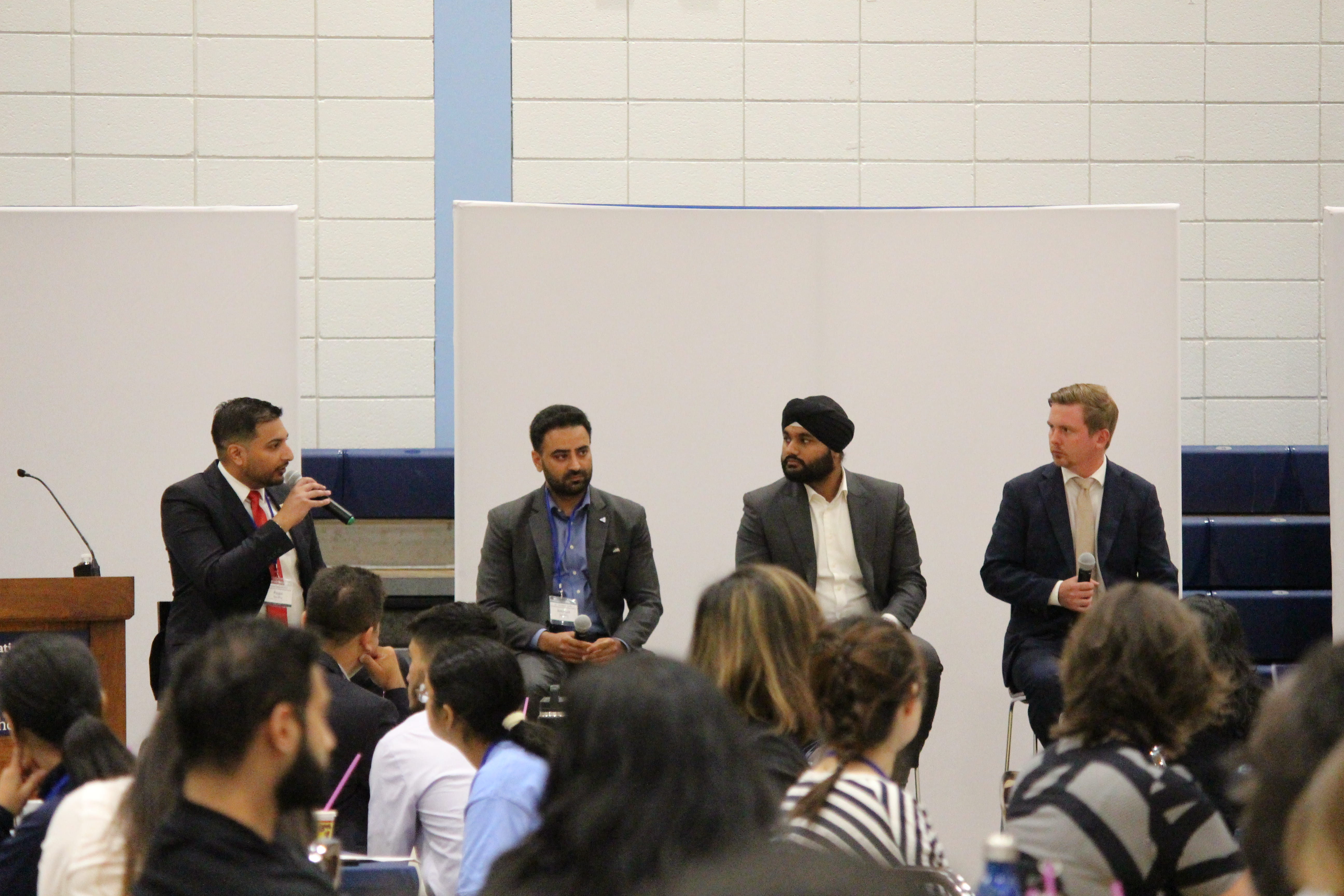 Moderator and members of government on stage