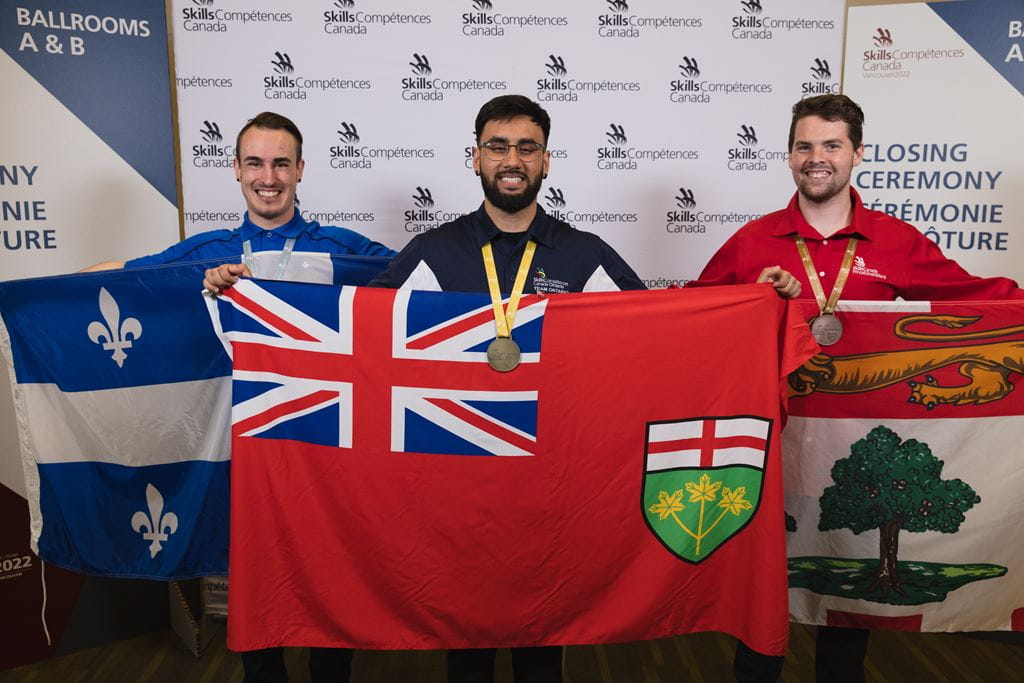 Sheridan student Akshit Vineet stands between students from Quebec (left) and Prince Edward Island