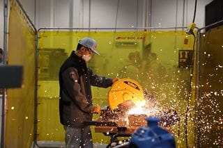 WorldSkills Competition 2022 Special Edition Industrial Mechanics champion Sota Morimoto of Japan uses a metal cutter