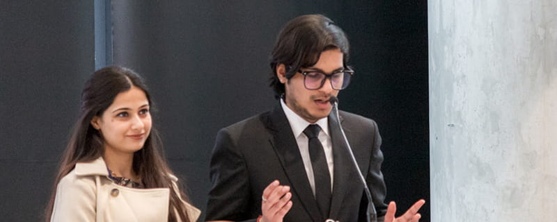 International students Roopam Jain and Mahima Kaur Anand take the podium.