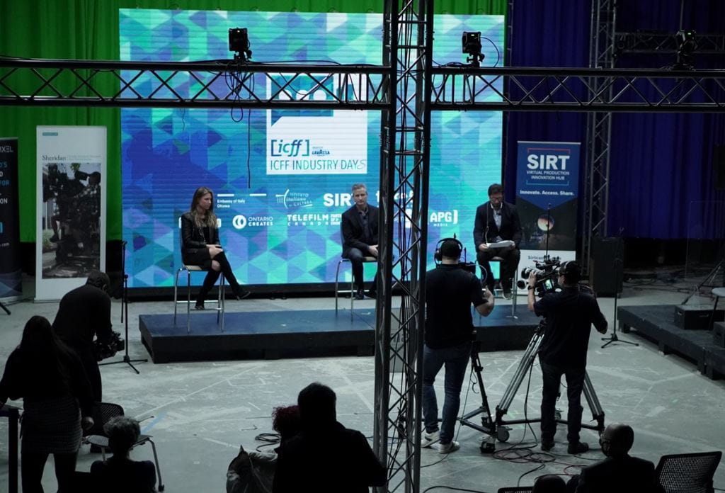Three presenters are filmed on the stage of SIRT during the ICFF Industry Days event.