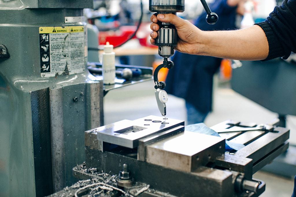 Close up of a student's hand working with a tool in a Sheridan skilled trades lab
