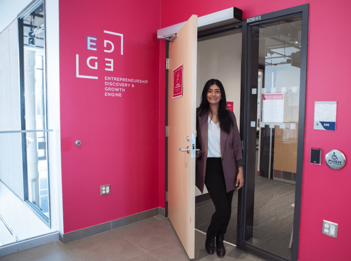 Person standing at an open door at the EDGE's entrance
