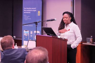 Aesha Brown presents at a podium