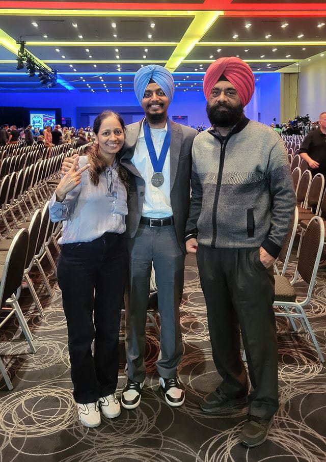 Sheridan student Hardeep Bansal poses for a photo between his mother and father