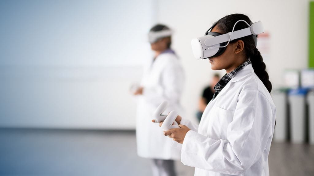 A student in a lab coat operates a virtual reality headset