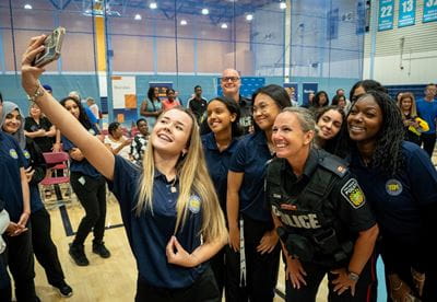 YIPI students take a selfie with a police officer