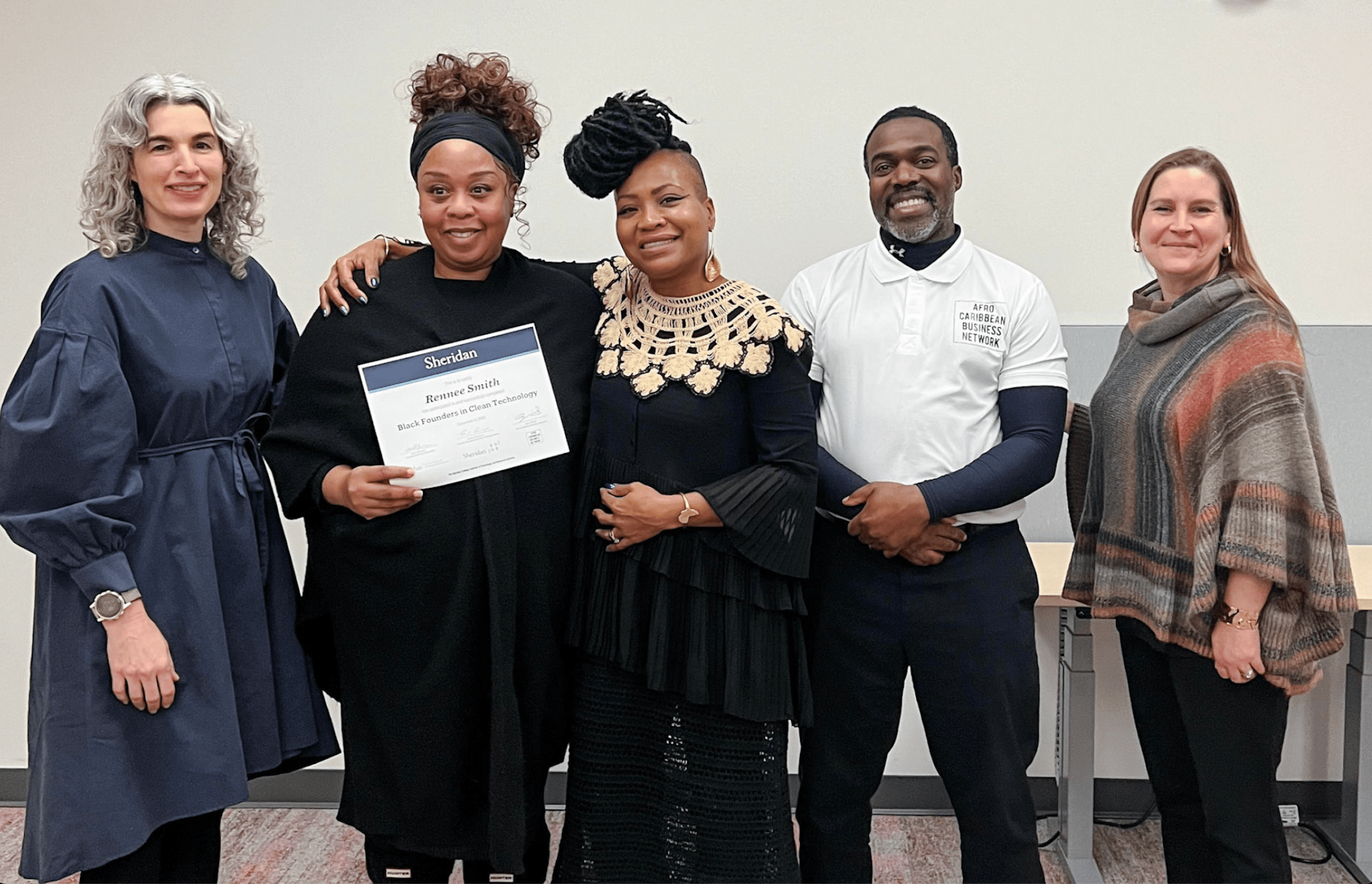 EDGE and ACBN representatives gather for a photo with a graduate of the Black Founders In Clean Technology certificate program.