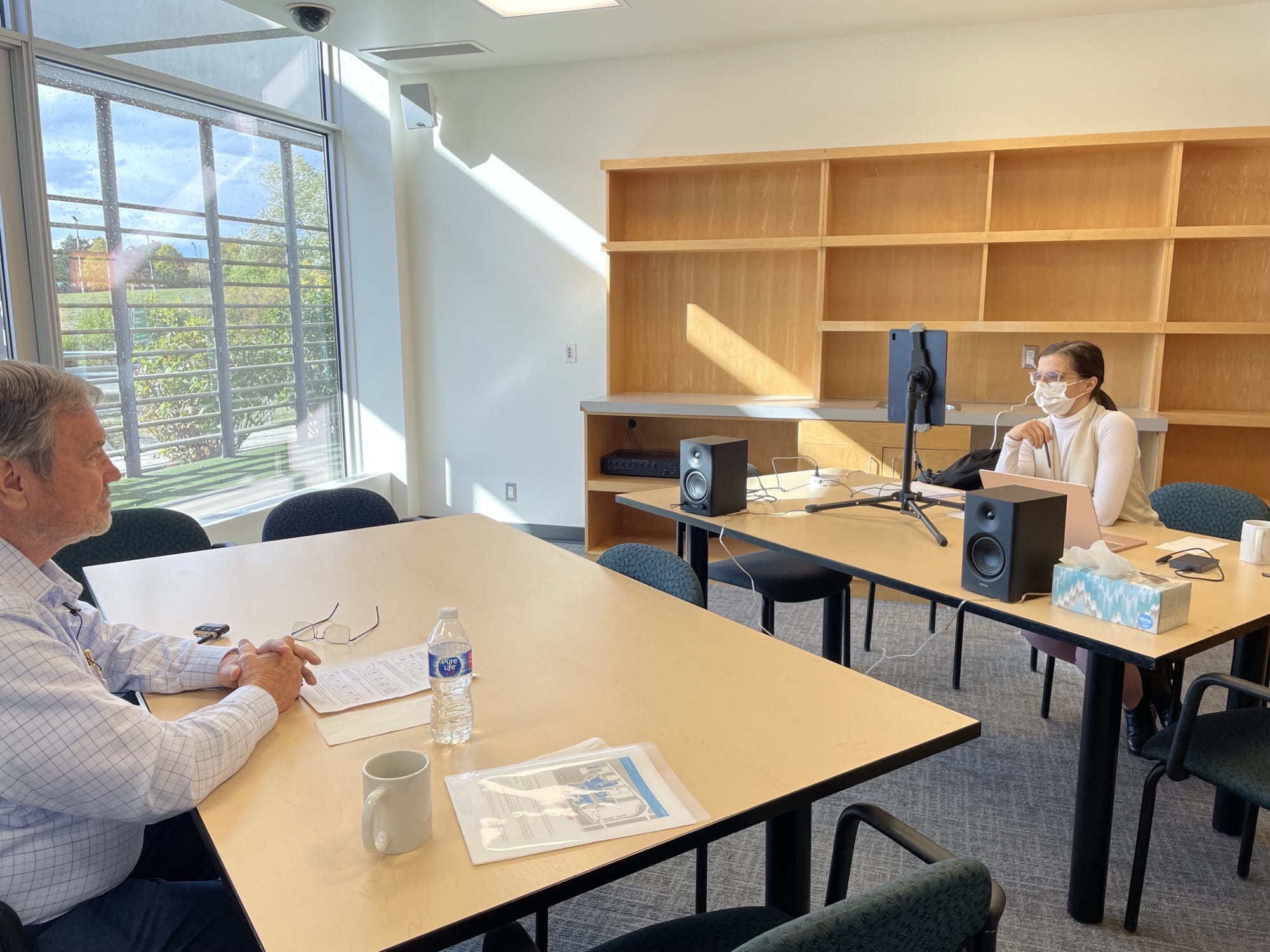 Seated at tables, LUCID researchers test their platform and set-up with older participants in a meeting room at the Centre for Elder Research. 