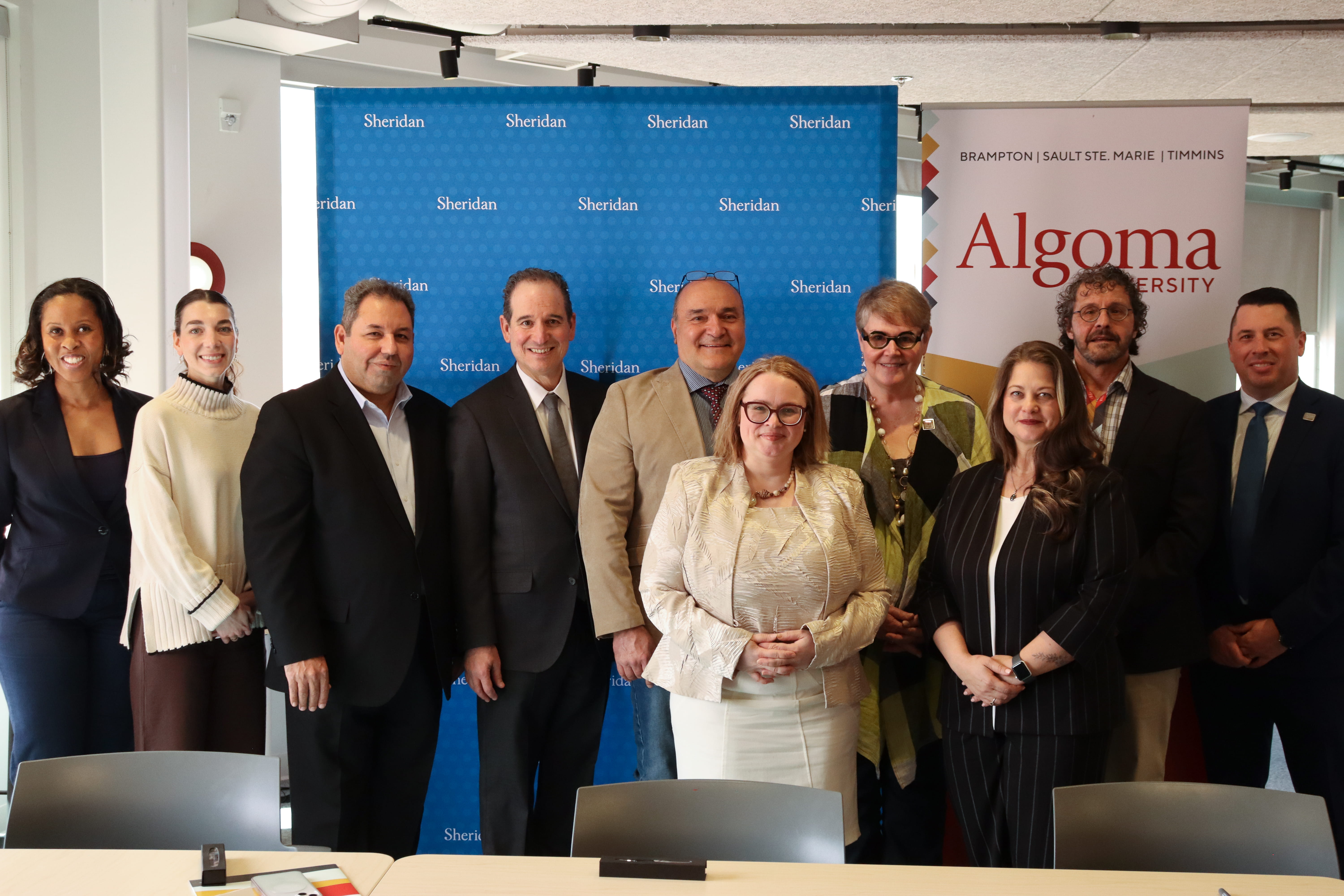 Officials from Algoma University and Sheridan College gather for a photo to celebrate their new partnership