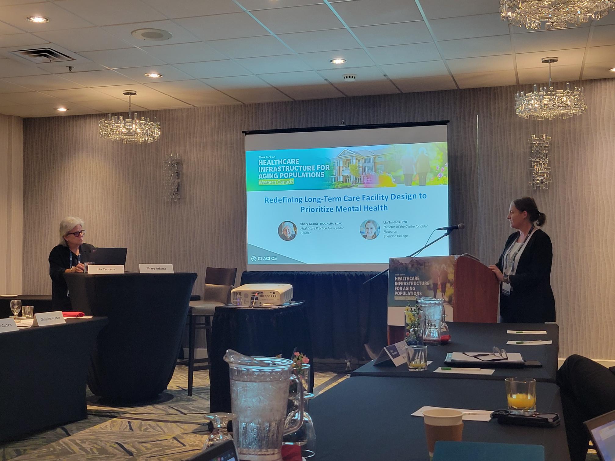 Generator at Sheridan Director of Research and Innovation Dr. Lia Tsotsos leads a presentation with a projector screen in the background