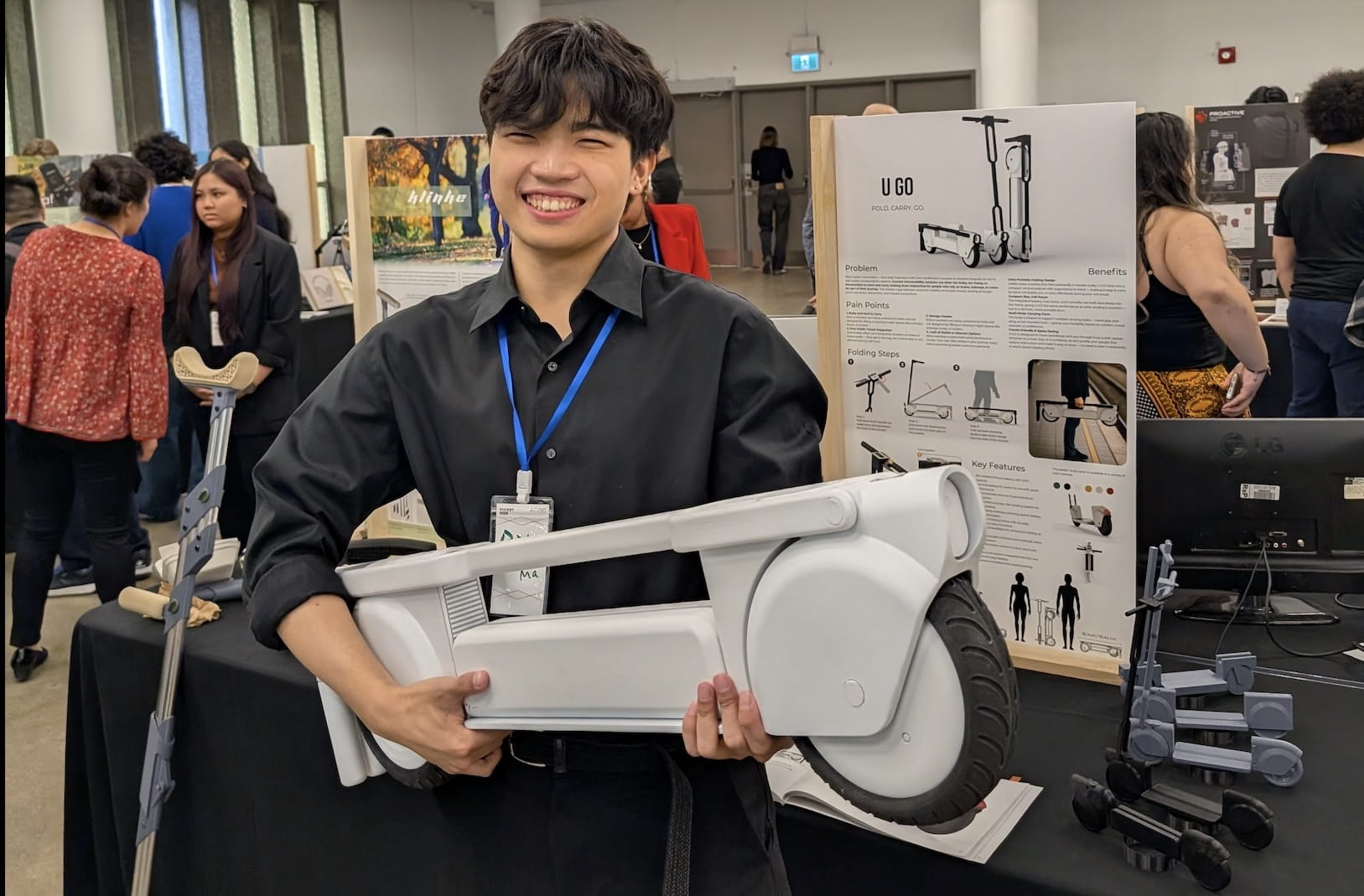 Bill Ma posing with his U GO project at the Rocket Awards competition.