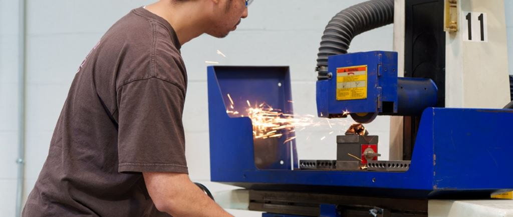 A student works on a machine at Sheridan's Magna School of the Skilled Trades