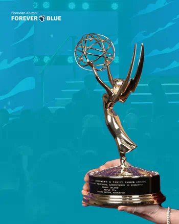 A hand holding a golden Emmy award trophy against a blue background.