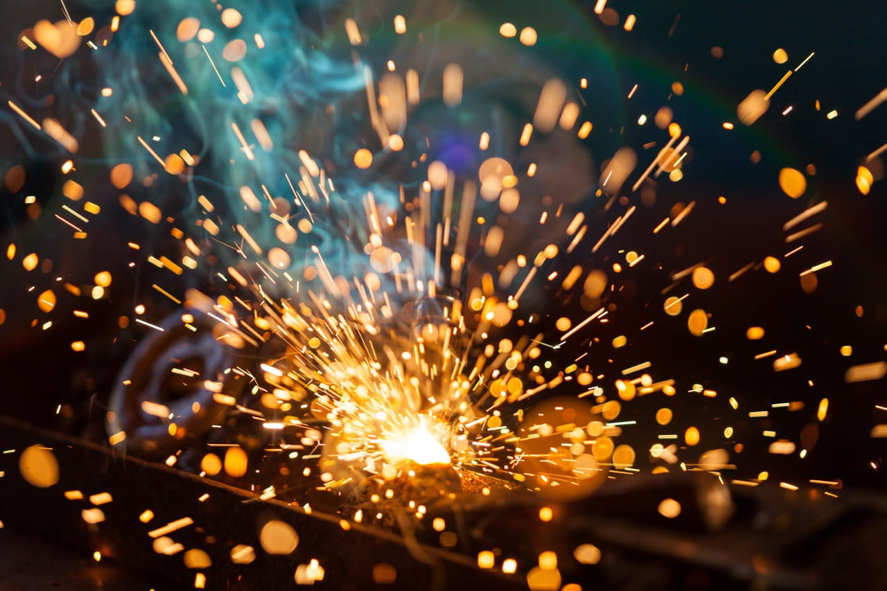 Sparks fly in the air as metal is welded
