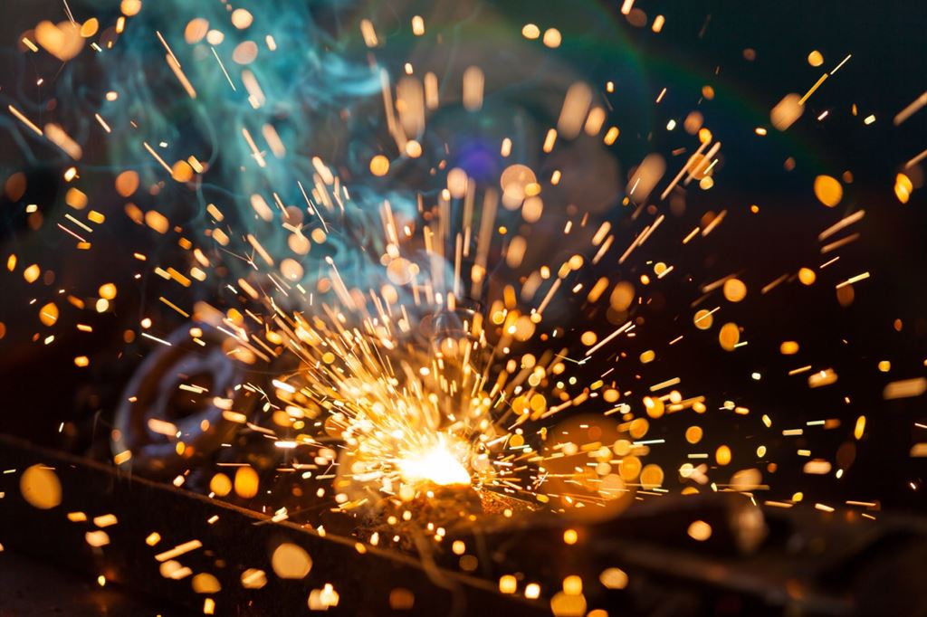 Sparks fly in the air as metal is welded