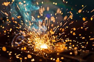 Sparks fly in the air as metal is welded