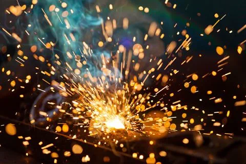 Sparks fly in the air as metal is welded