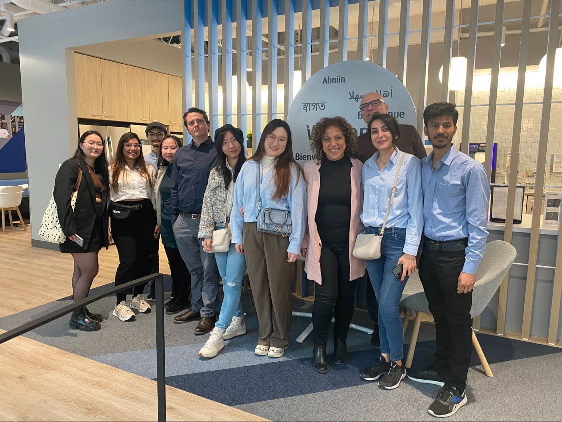 A group photo of Sheridan Digital Product Design students and their professor at BMO Place in Toronto