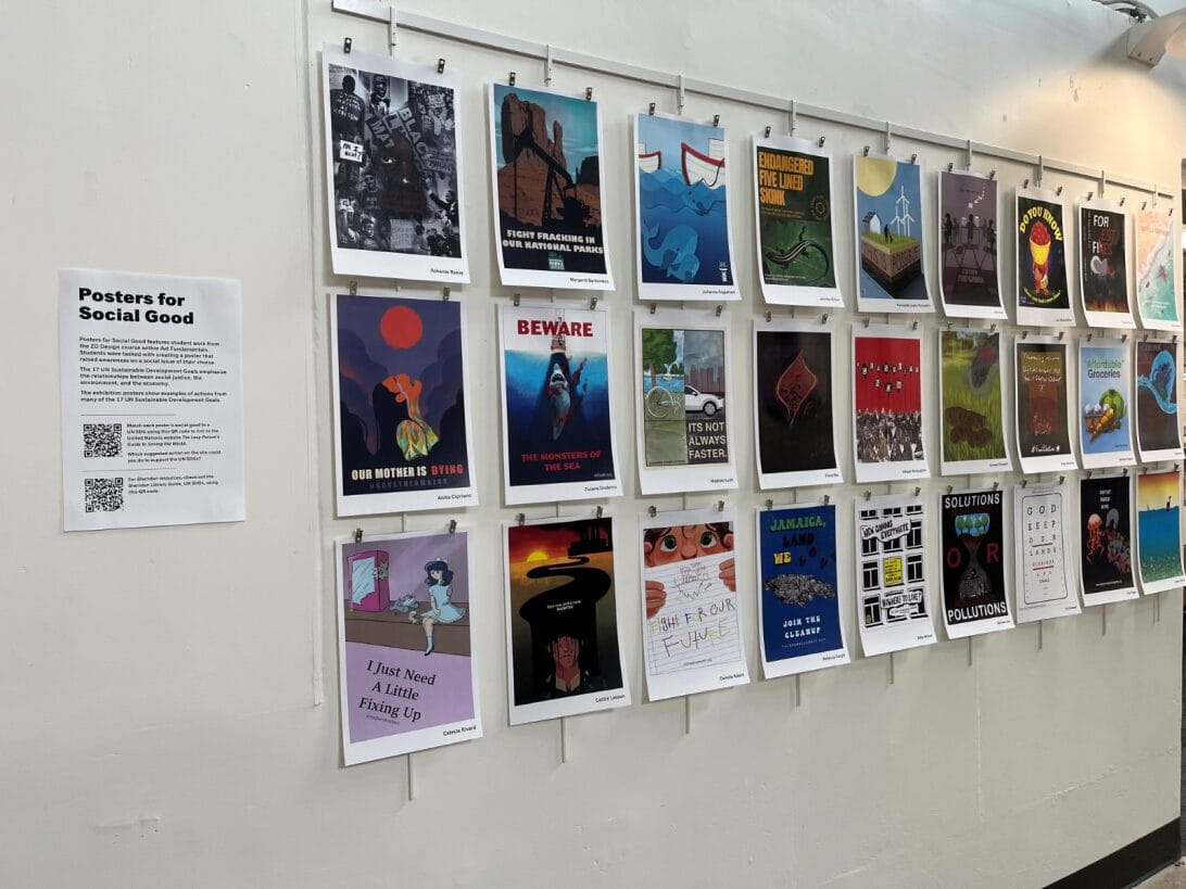 A wall displays three rows of posters created by students