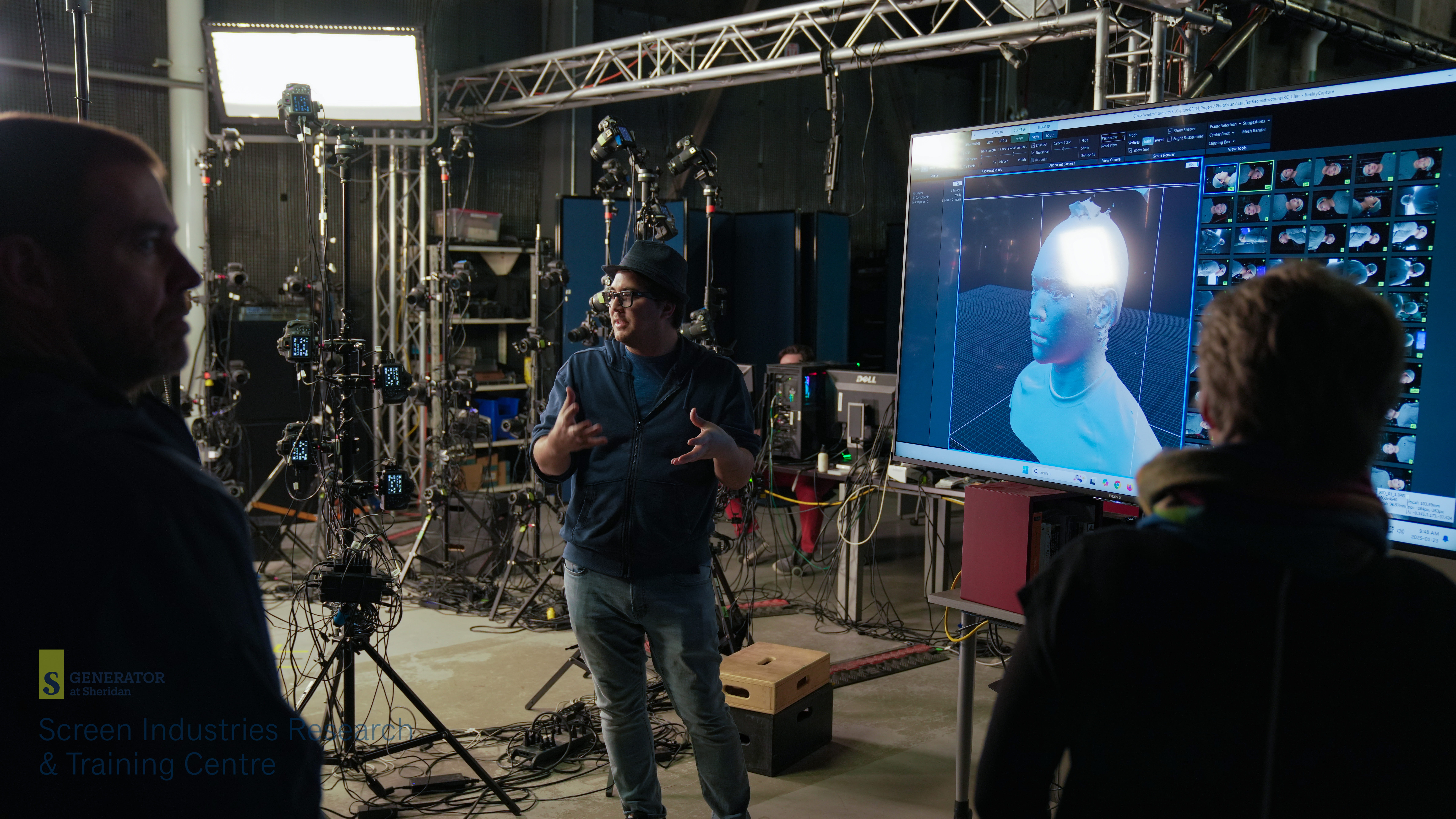 SIRT Virtual Production lead Spencer Idenouye stands next to a screen during a discussion about the Centre's technical capabilities