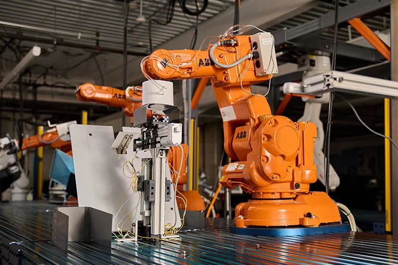 A Practical Camera-Guided Robotic Cell for Trans-former Sheet Stacking