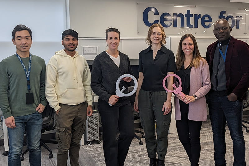 Six people standing holding tools