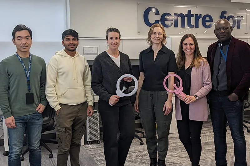 Six people standing holding tools